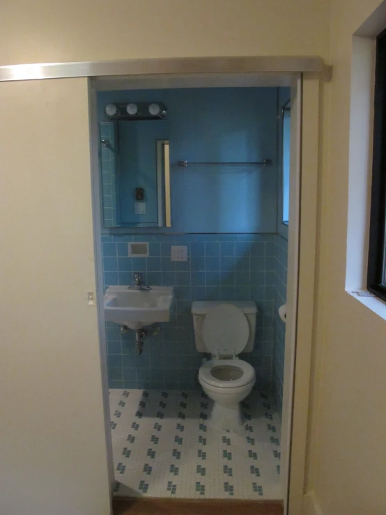 a bathroom is shown with a toilet and sink