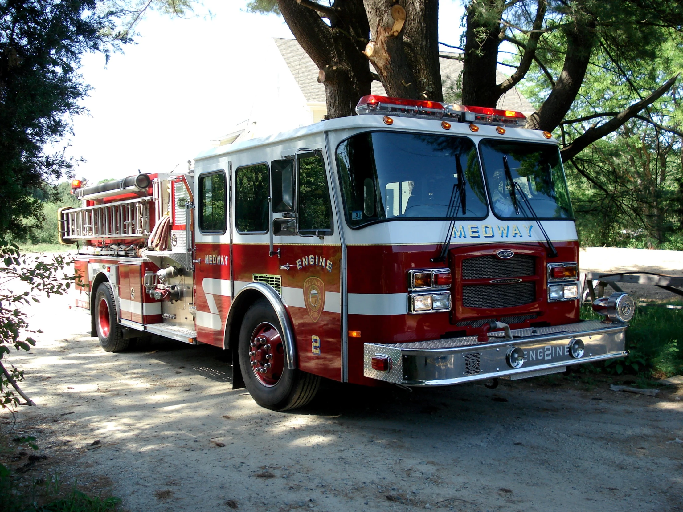 a firetruck parked near a large tree