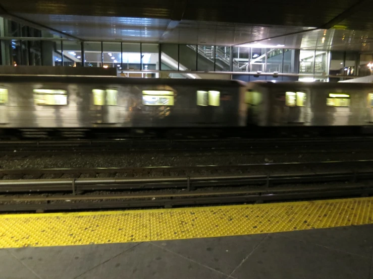 a subway train traveling down the track at night