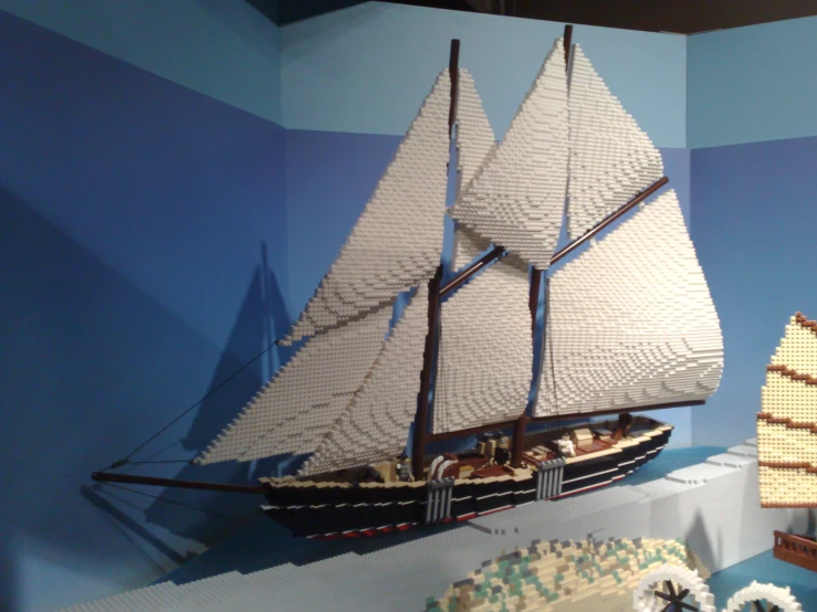 a model ship is sitting next to a couple of cakes