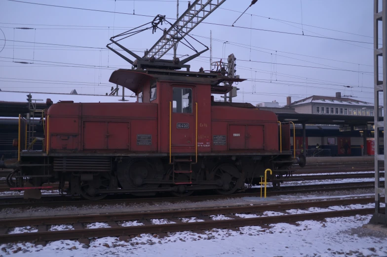 red caboose sitting in front of a train station