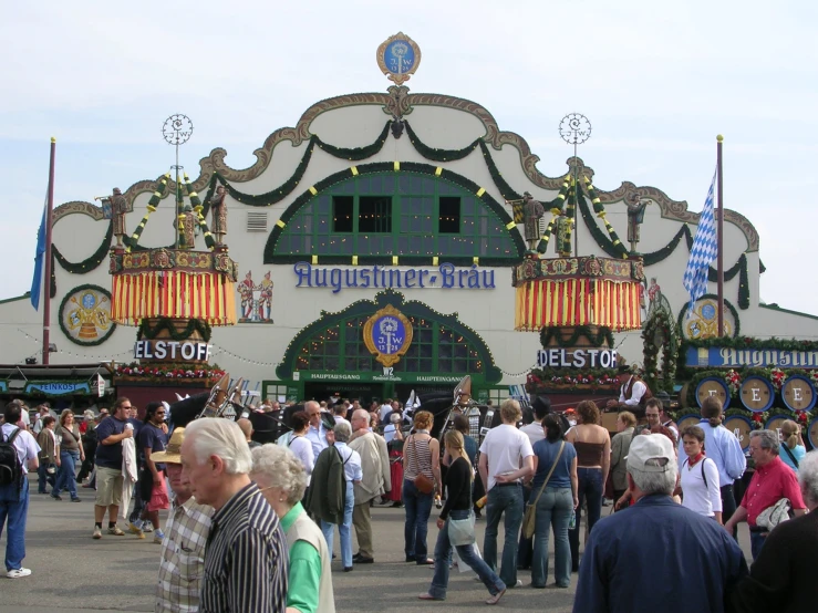 many people walk around outside in front of the main building