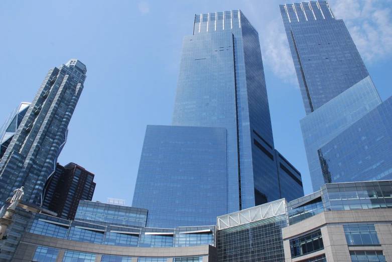 some very tall buildings in front of a blue sky