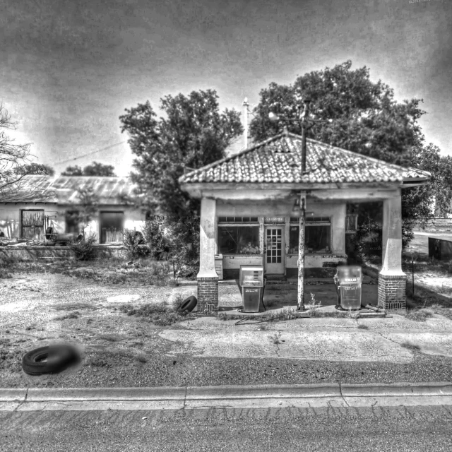 black and white image of old gas pumps