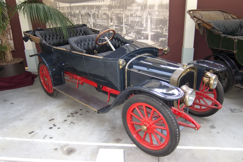 a vintage antique car parked in the middle of a garage