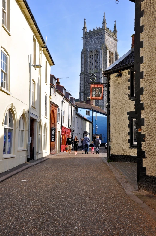 a narrow road is blocked off by tall buildings