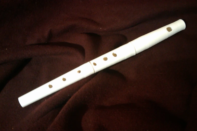 a white flute laying on a brown background