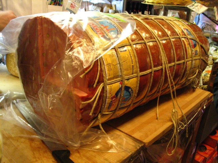 a large, wooden structure made from raw meat sits on a table