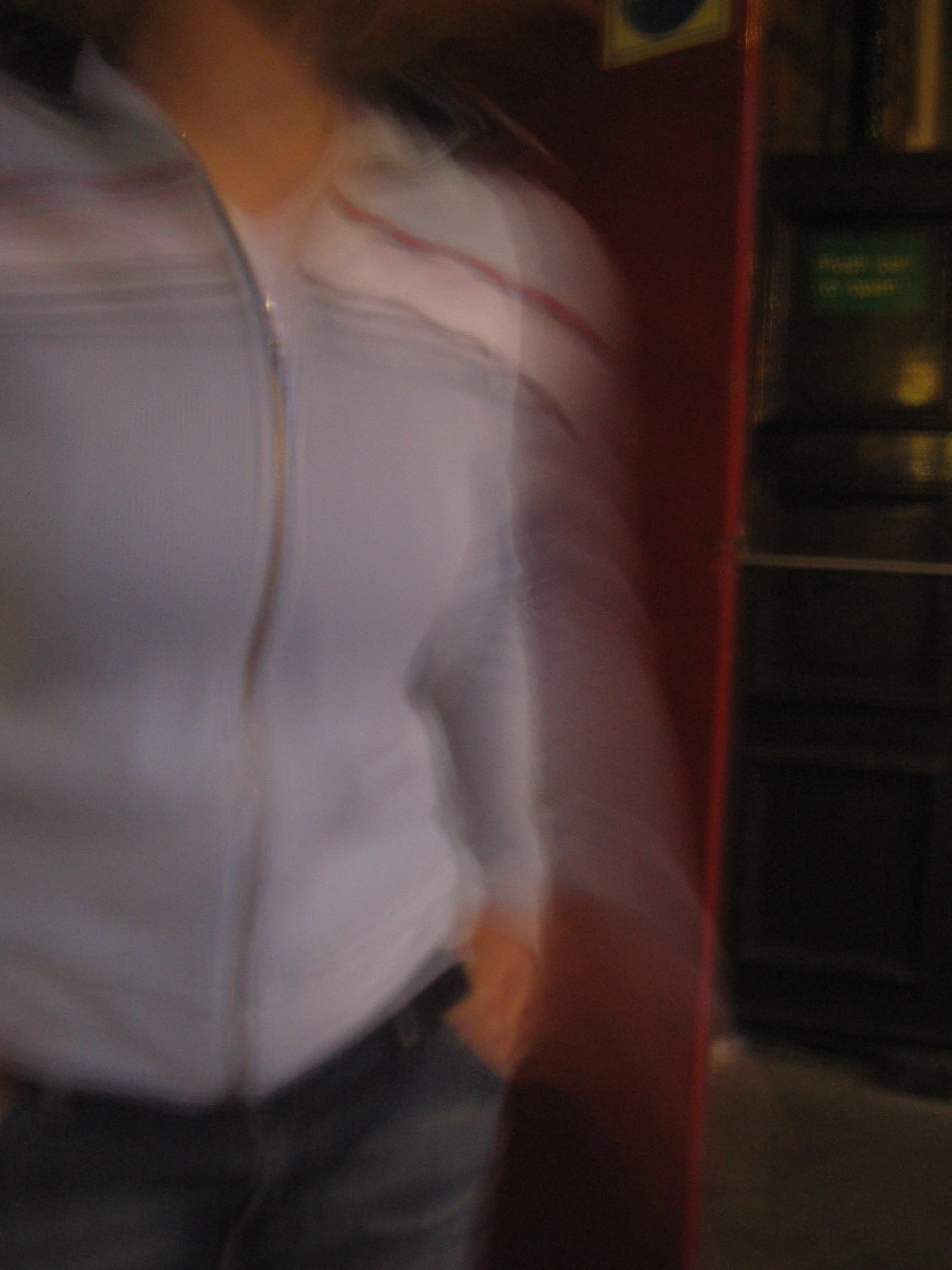 woman in white shirt in motion by a brick wall