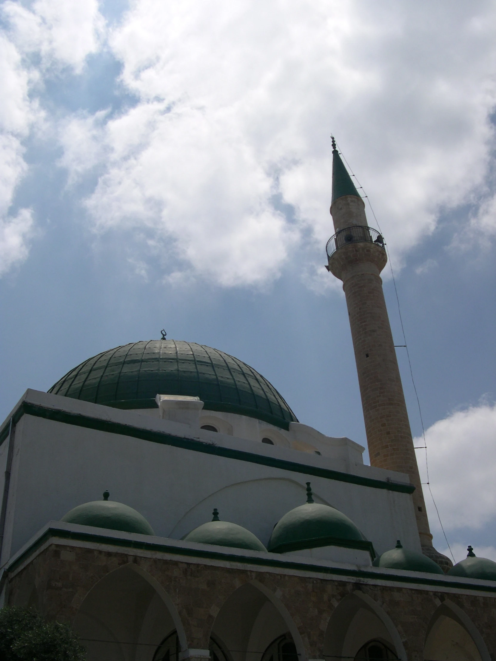 large dome with green roof surrounded by two smaller white building