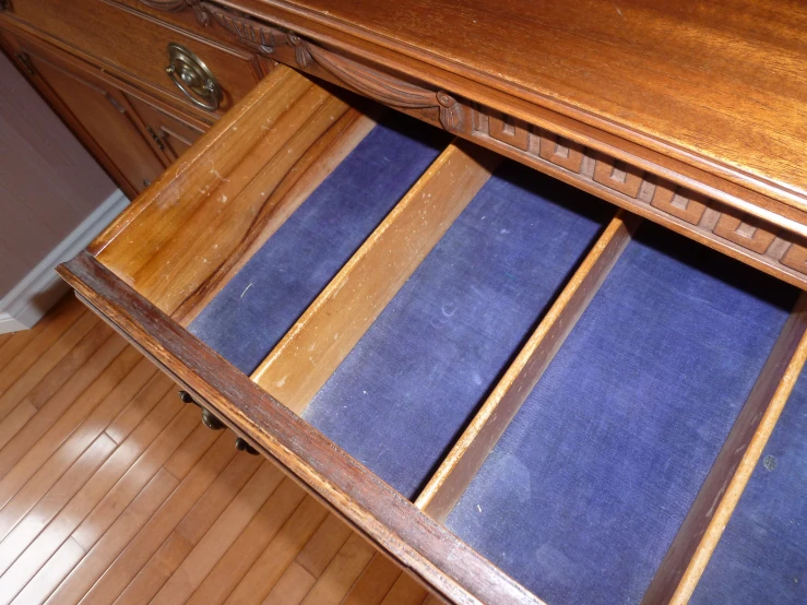 the blue rugs are placed underneath the wooden cabinet