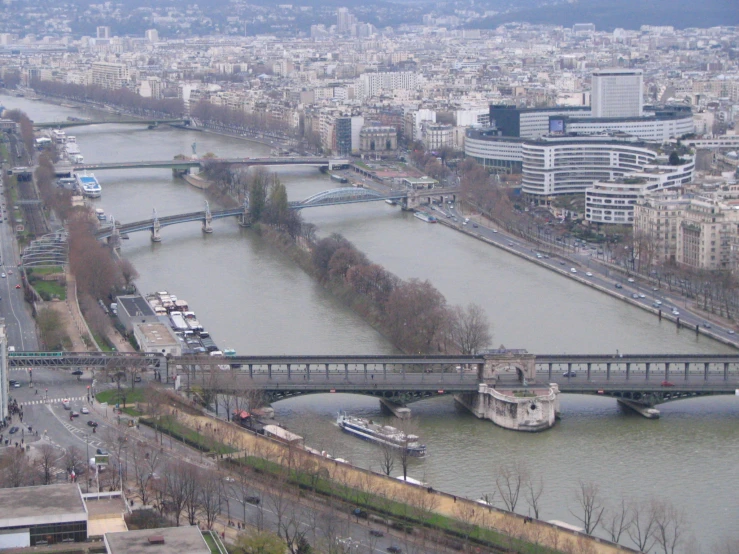 a bridge over the river running through a city