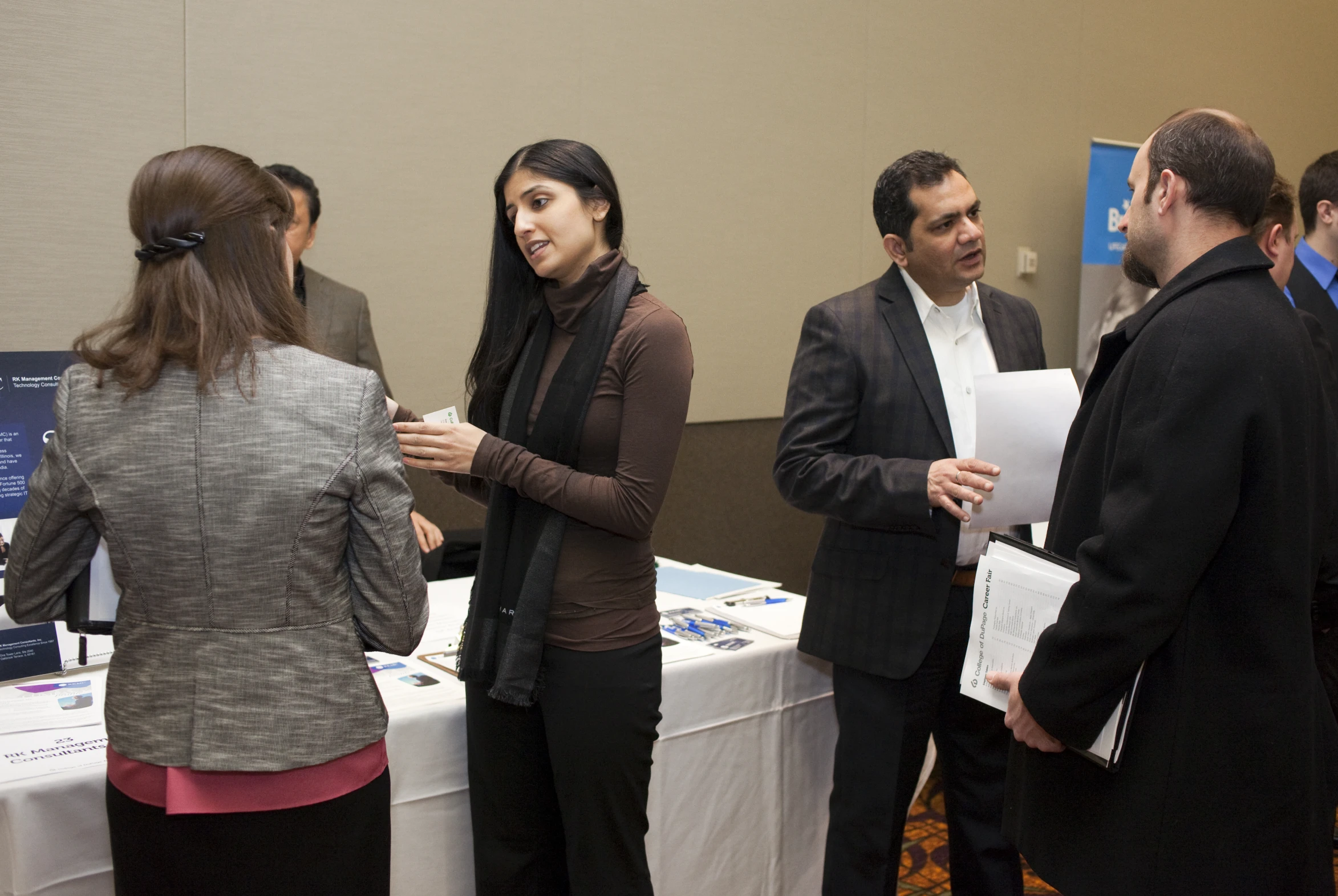 a group of people standing in front of a table