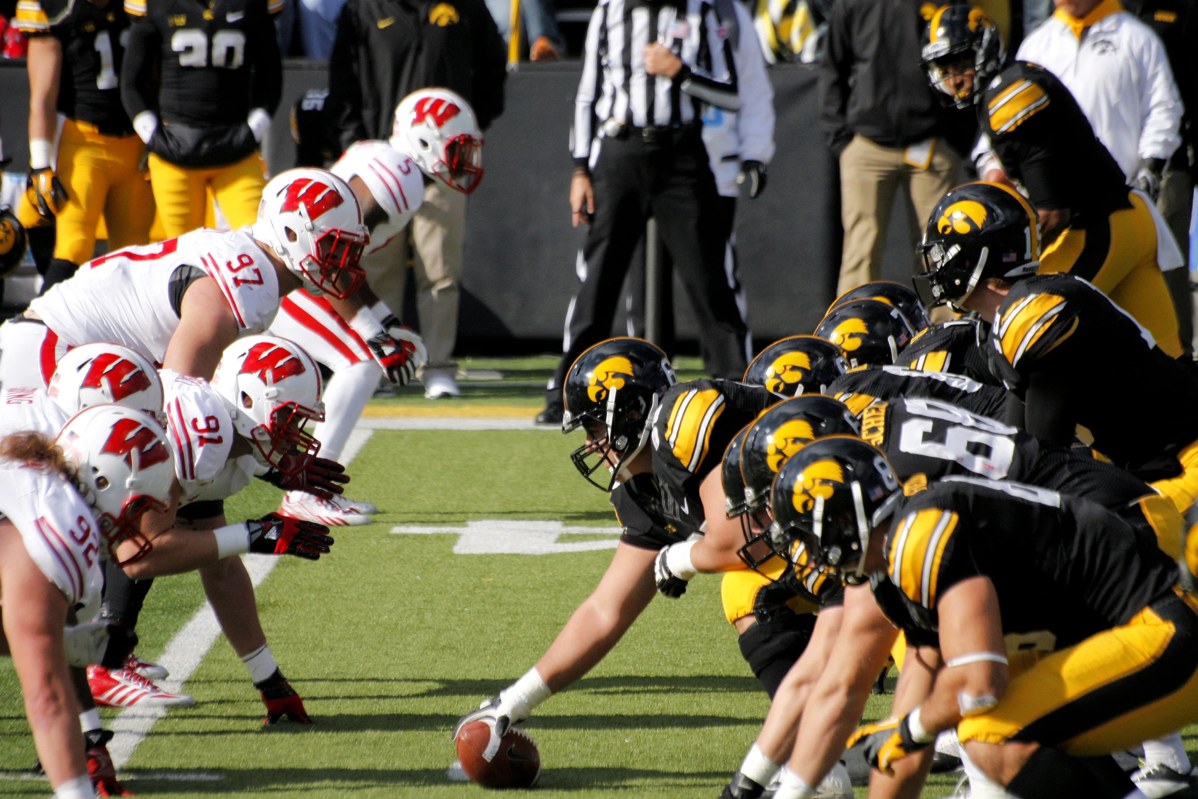 many players in a line with their hands extended