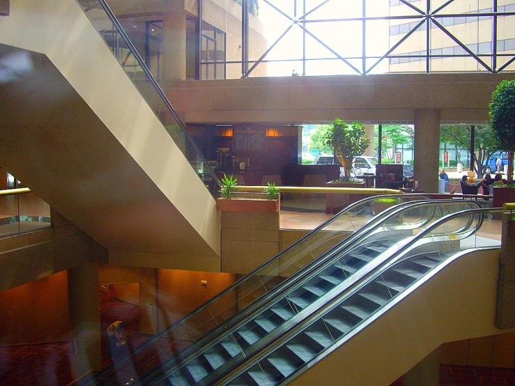 an escalator that is next to a person riding on an escalator