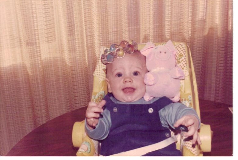 a small child with a stuffed pig on his head