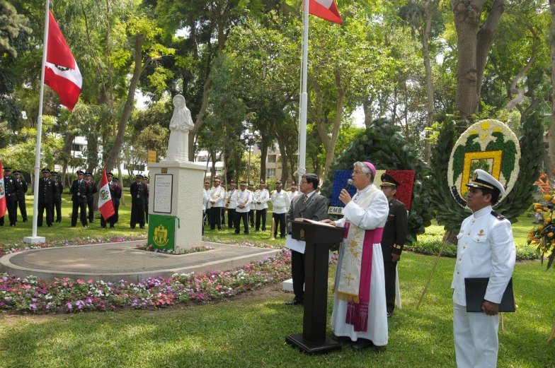 the people in uniform are looking at the flags