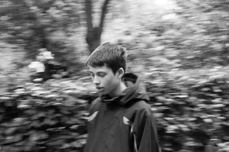 black and white po of a man in front of a forest