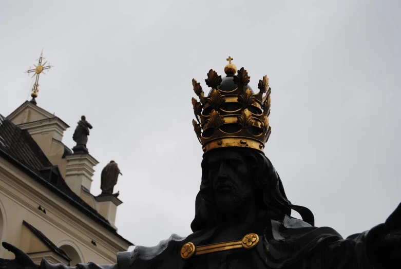 a large black statue sitting in front of a building