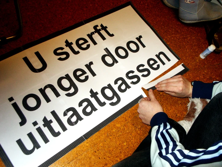a person  paper that reads u - staff longer door ultratagsee