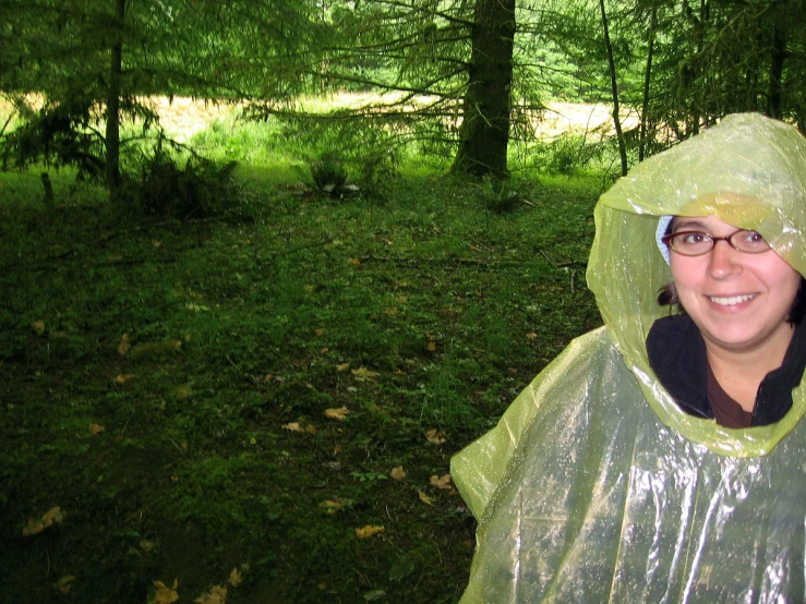 a woman with a plastic rain coat over her head