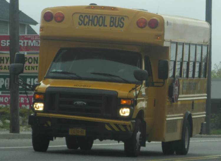 the school bus is traveling down the street