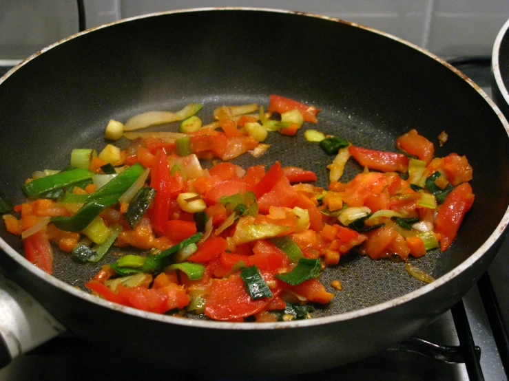 vegetables being cooked in a pan on the stove