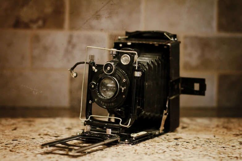 a small camera laying on a counter in the bathroom