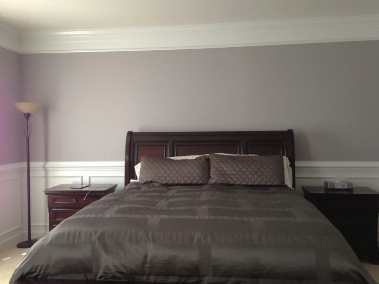 a bedroom with a wooden headboard and night stand