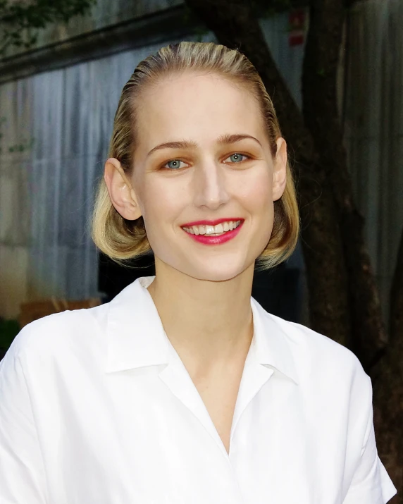 a woman standing smiling for the camera