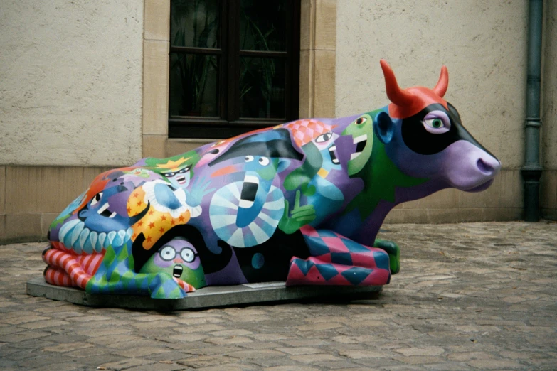 the statue of a cow is colored brightly