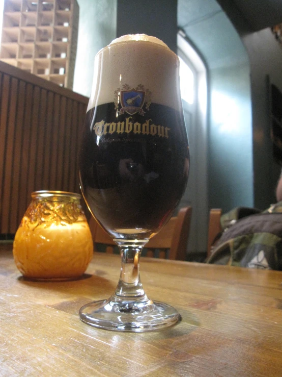 a drink on top of a table with an orange sitting on the table