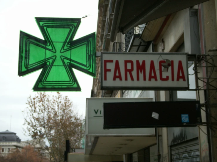 a cross sign is hanging from a building