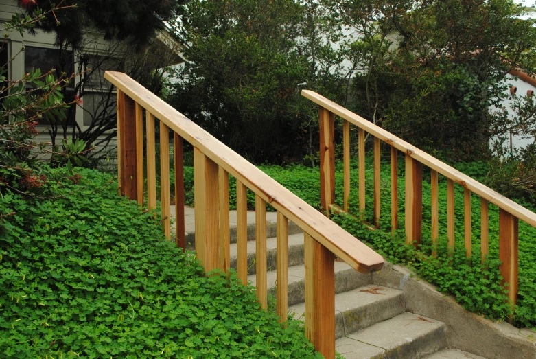 a very big wooden hand rail down some steps