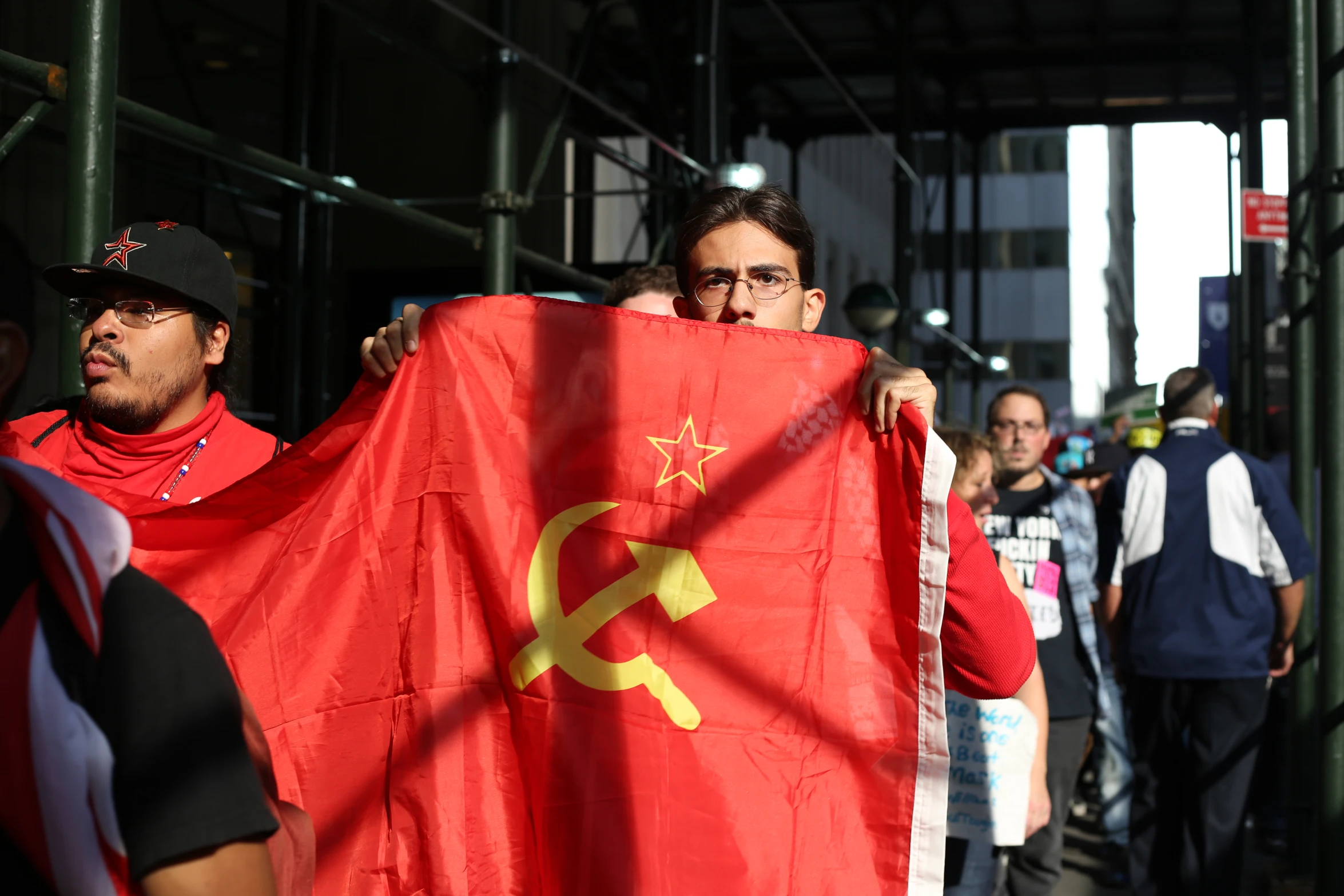 the two men are holding the flags with the communist symbol