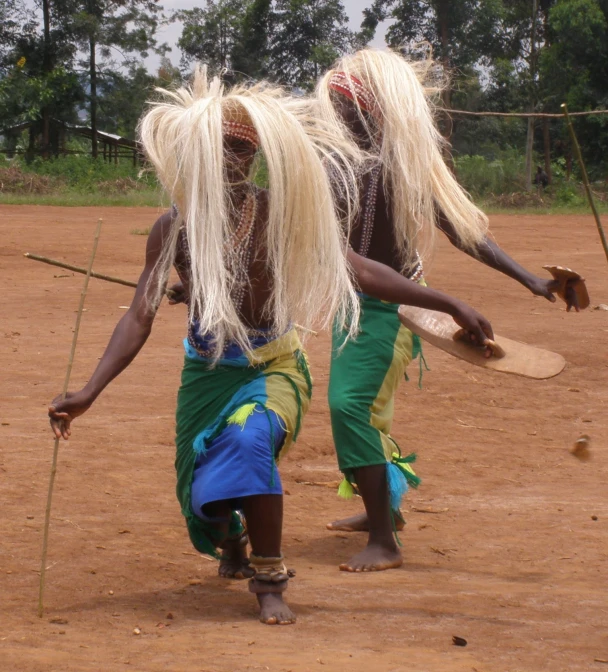 two men from tribe are playing in the dirt