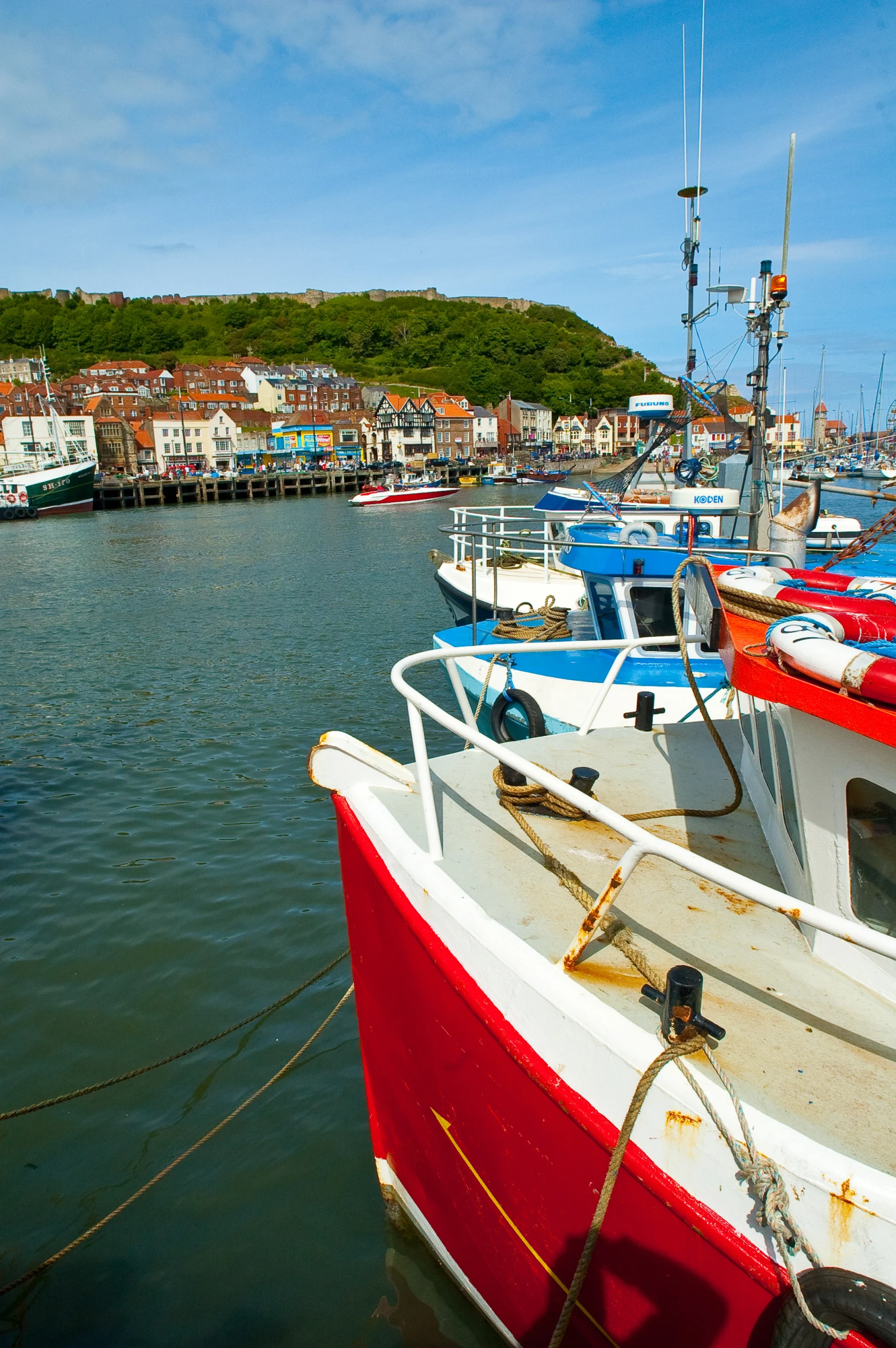 several boats are parked on the water near each other