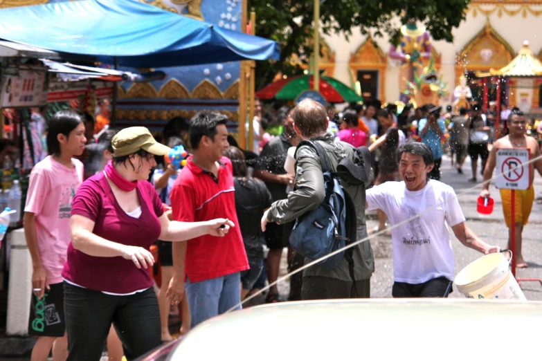 group of people walking through a crowded market area