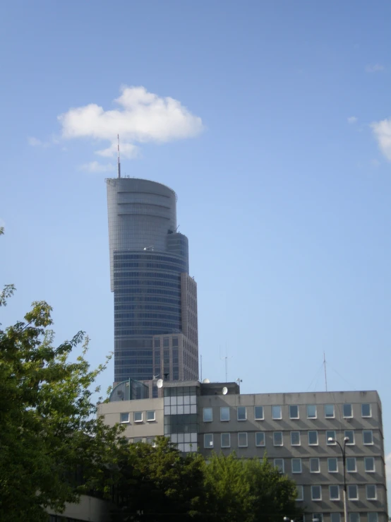 a building in front of a city blue sky