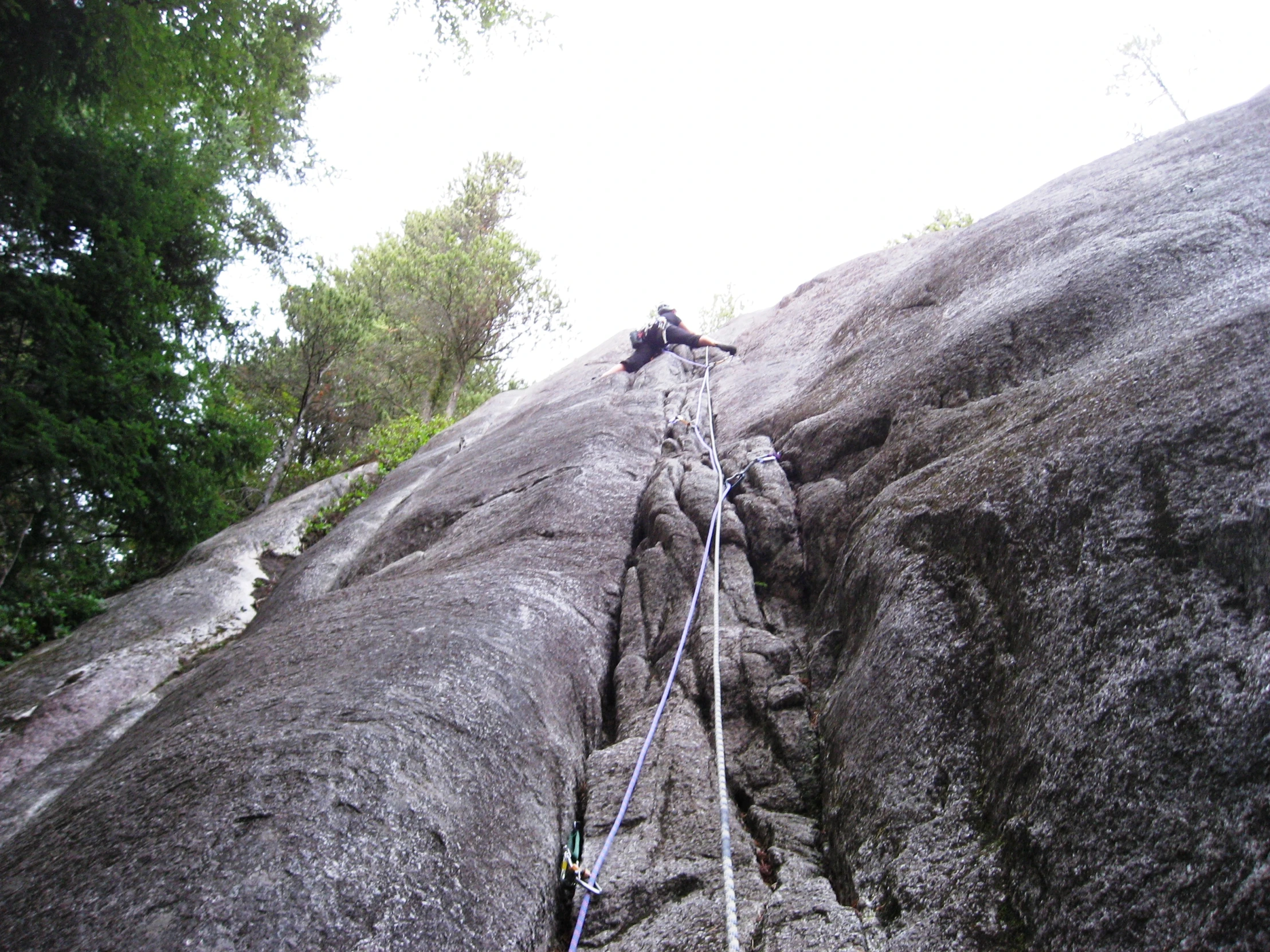 a person climbing up the side of a rock