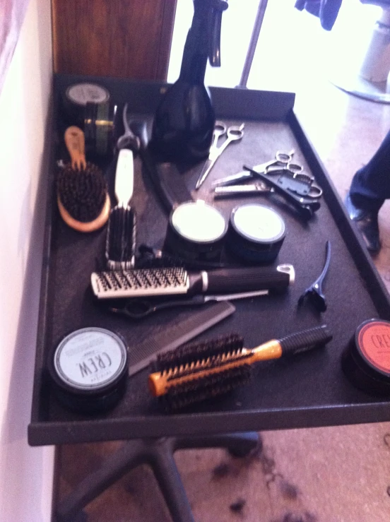 a hair dresser that has various types of combs, brushes and other beauty items