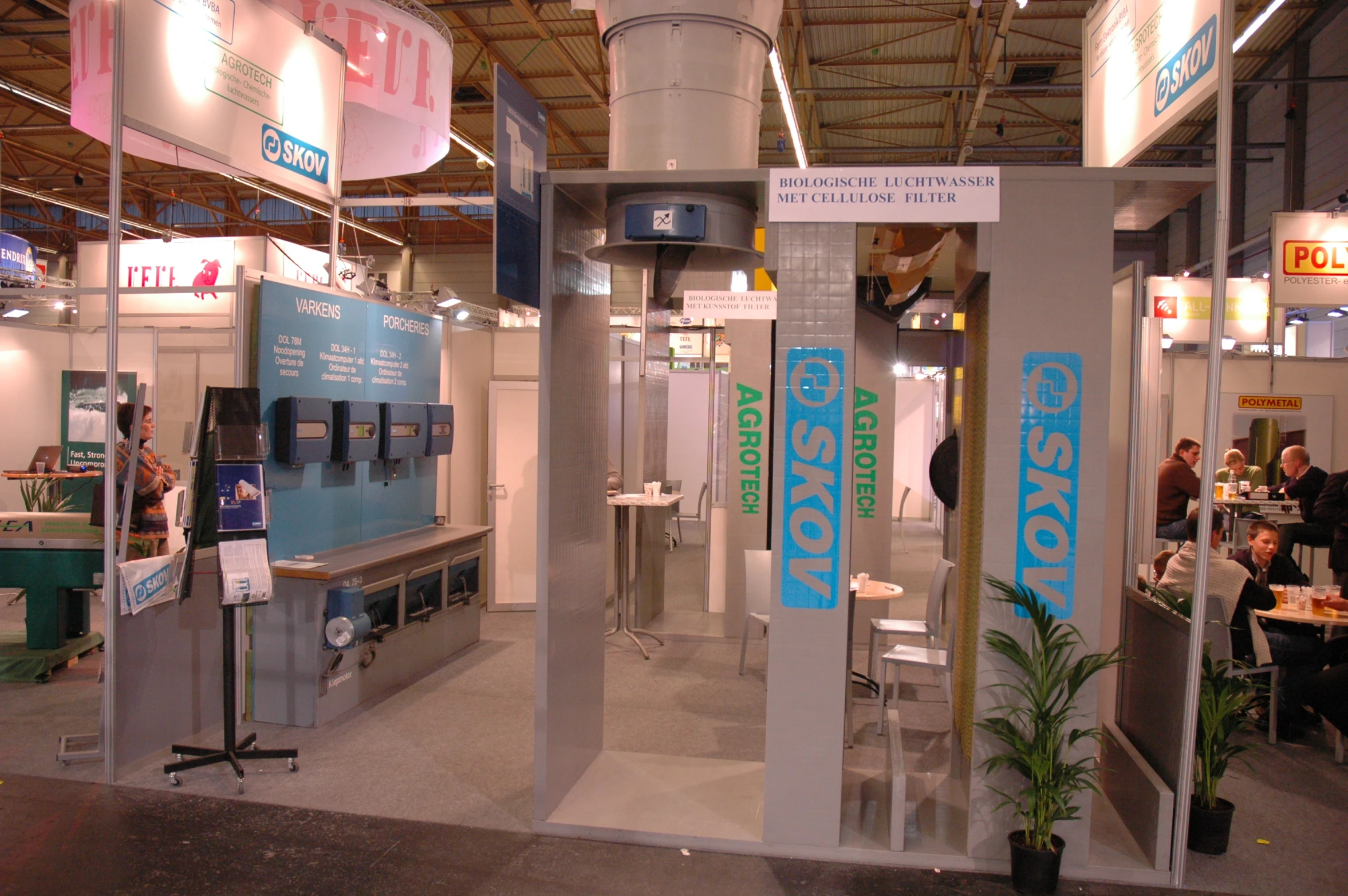 an exhibit room with a white blue and green sign