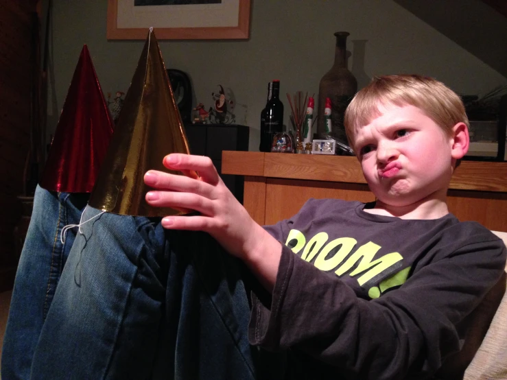 boy sitting on couch with pants hanging upside down