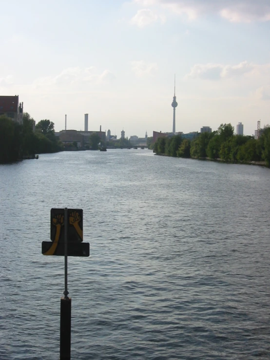 a sign is located along the side of the river