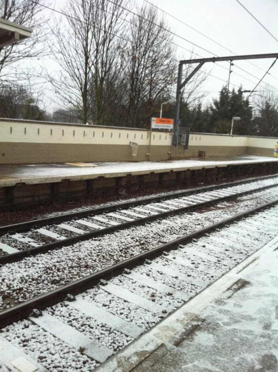 several trains sitting next to each other in the snow