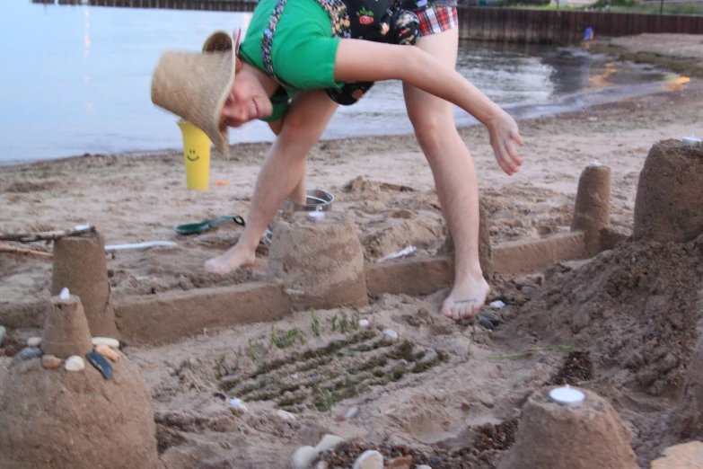 the boy is playing with sand castle construction