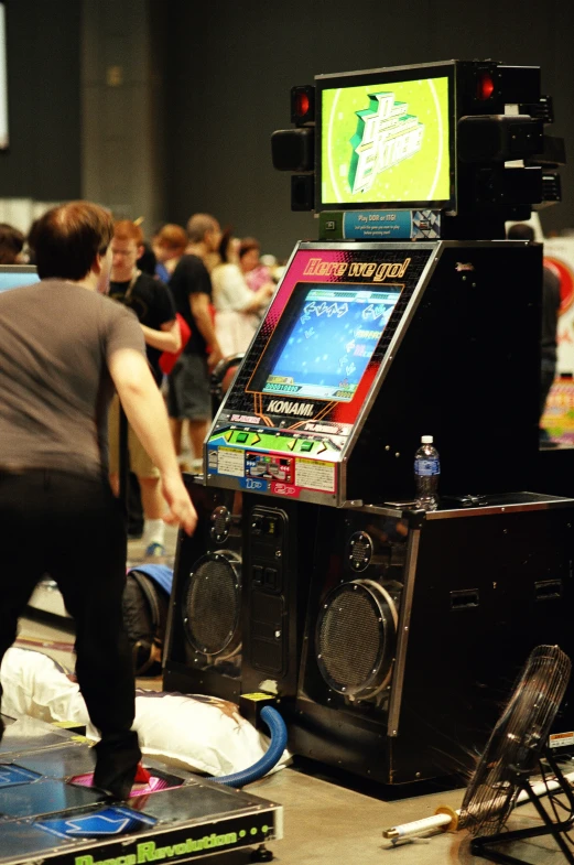 an arcade machine in front of a large group of people