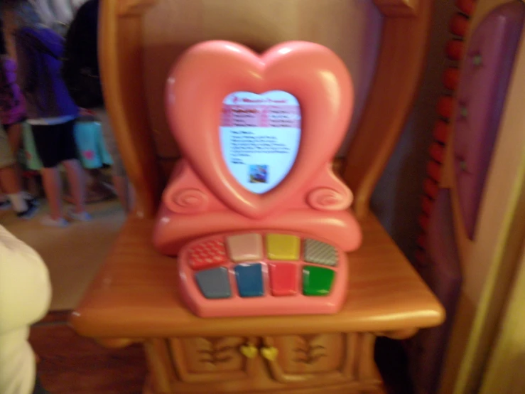 there is a pink dollhouse with a heart shaped mirror on it