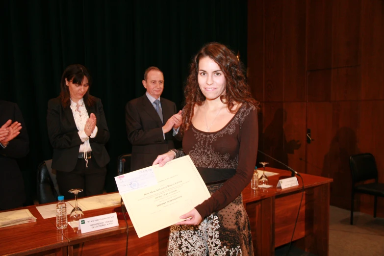 a lady standing in front of a board at a conference