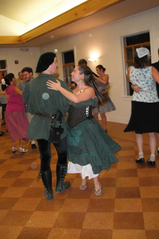 a couple dance together at the end of a party